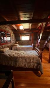 a bedroom with two beds in a cabin at Villa Berna Casa Boutique in Villa Berna