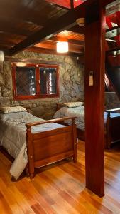sypialnia z 2 łóżkami w kamiennym pokoju w obiekcie Villa Berna Casa Boutique w mieście Villa Berna