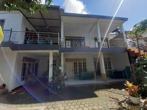 a view of a house with a balcony at Riana's Homestay in Rantepao