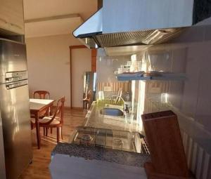 a kitchen with a sink and a table in a kitchen at Londrina Flat Hotel - Apto completo in Londrina