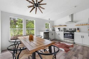 a kitchen with a wooden table and some chairs at Starlight Horizon Cabin E - Pet-Friendly Texas Hill Country Cabin Near Canyon Lake - Pool, Stargazing & Group Getaways - Sleeps 8 in Canyon Lake