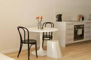 a white table and two chairs in a kitchen at Collingwood Studio Hideaway in Melbourne