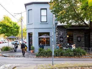 a group of people sitting outside of a restaurant at Collingwood Studio Hideaway in Melbourne +8 photos