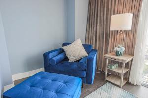 a blue chair and a stool in a living room at Luxury view in Toronto Downtown 3 Bedroom 2.5 Bathroom 1 Parking in Toronto