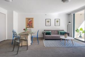 a living room with a couch and a table at Top of the Town with Sydney CBD at its Doorstep in Sydney