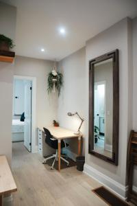 an office with a desk and a mirror at Toronto Junction Hideaway in Toronto