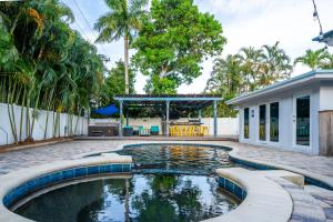 a swimming pool in the backyard of a house at Life is Blue in Fort Lauderdale