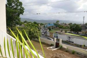 a view of a city street with cars on the road at The Shelton Tower 1 in Montego Bay