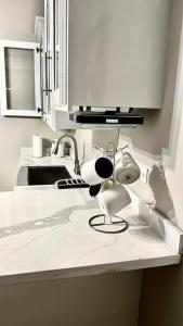 a kitchen counter with a hair dryer and a sink at The Shelton Tower 1 in Montego Bay