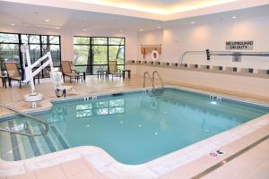 a large swimming pool in a hotel lobby at Courtyard by Marriott Boston Waltham in Waltham