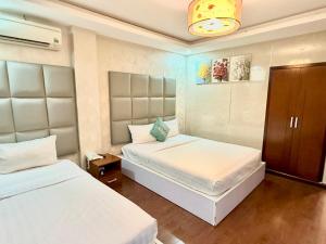 Postel nebo postele na pokoji v ubytování ACE Hotel - Bến Thành