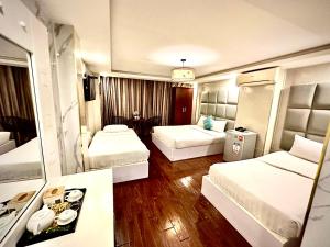 Postel nebo postele na pokoji v ubytování ACE Hotel - Bến Thành