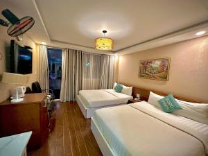 מיטה או מיטות בחדר ב-ACE Hotel - Bến Thành