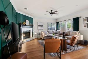 a living room with a couch and a fireplace at The Mad Hatter - Heated Pool Gameroom & More in Pflugerville