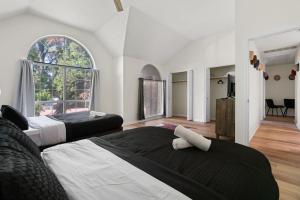 a bedroom with two beds and a large window at The Mad Hatter - Heated Pool Gameroom & More in Pflugerville +42 photos