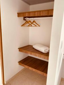 um armário com prateleiras de madeira e uma almofada em VILLA CRISTAL em Santa Helena