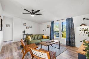 a living room with a green couch and a table at Starlight Horizon Cabin M - Pet-Friendly Texas Hill Country Cabin Near Canyon Lake - Pool, Stargazing & Group Getaways - Sleeps 8 in Canyon Lake +39 photos
