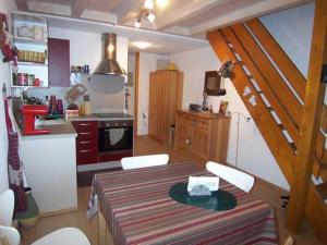 a kitchen with a table and chairs and a kitchen with a staircase at Appartement Morzine, 2 pièces, 4 personnes - FR-1-754-67 in Morzine