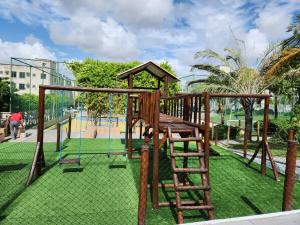 a playground with a ladder and a swing at Apartamento Compacto Mobiliado in Natal