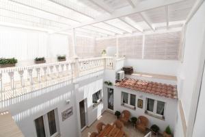 an overhead view of a building with a balcony at Sitges Centre Mediterranean House- 5 Bedroom, 4 Bathroom, Terrace Courtyard, Private Rooptop Pool in Sitges