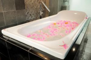 a bath tub filled with pink icing and flowers at Dzawani Villa Ungasan in Uluwatu +18 photos