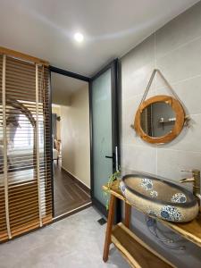 a bathroom with a sink and a mirror on the wall at Hue Sweethouse 2 Homestay in Hue