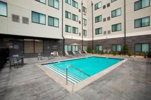 a swimming pool in front of a building at Residence Inn by Marriott Tulsa Downtown in Tulsa