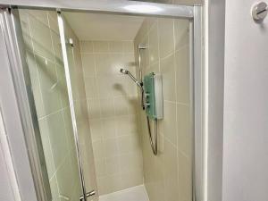 a shower with a glass door in a bathroom at Balne Mill Grove in Wakefield +19 photos