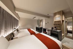 a hotel room with a bed and a desk at the b namba-kuromon in Osaka