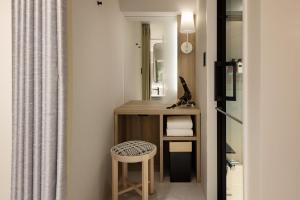 a room with a desk and a stool and a mirror at the b namba-kuromon in Osaka