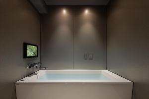 a large white tub in a bathroom with a window at the b namba-kuromon in Osaka