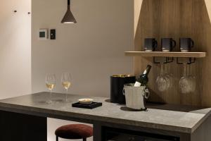 a kitchen with two glasses of wine on a counter at the b namba-kuromon in Osaka