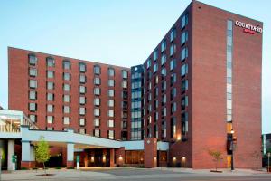 a large red brick building with a sign on it at Courtyard by Marriott St. Cloud in Saint Cloud