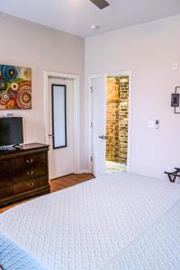 a bedroom with a bed and a dresser and a window at Cityscape 2 -Sleep 7 in Chattanooga