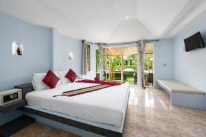 a bedroom with a large white bed and a balcony at Avocado Koh Samui in Bophut 