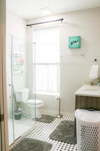a bathroom with a toilet and a glass shower at Cityscape 2 -Sleep 7 in Chattanooga