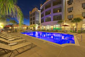 a pool in front of a hotel at night at Courtyard by Marriott Houma in Houma