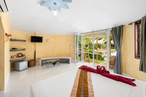 a living room with a couch and a tv at Avocado Koh Samui in Bophut 