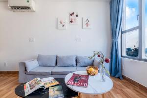 a living room with a couch and a table at RiverGate Residence Apartment - The Origin in Ho Chi Minh City