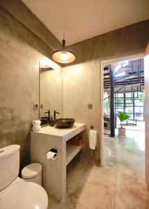 a bathroom with a sink and a toilet at Berawa Lofts #2 Managed by CPM Bali in Canggu