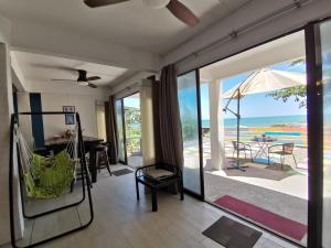 a living room with a view of the ocean at Greenage Seaview Bay Villa with stunning sunset in Putatan