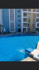 a large blue swimming pool in front of a building at غرفة فندقية في جولف بورتو مارينا in El Alamein