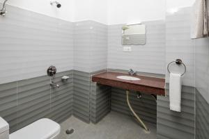 a bathroom with a sink and a toilet at Vella Marina Group of hotels Mcleodgunj in Dharamshala