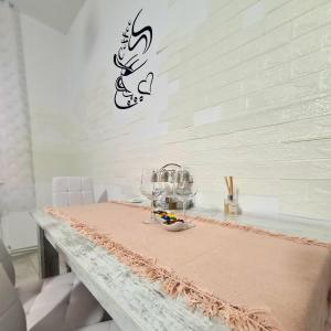 a table with a bowl of food on a wall at Mural Art Apartament in Petroşani