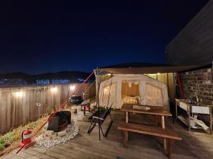 a tent is set up on a deck at night at Hotel 498 in Incheon
