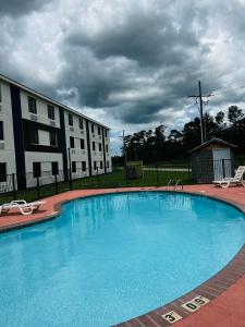 a large blue swimming pool in front of a building at Quality Inn & Suites Lake Charles in Lake Charles