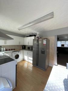 a kitchen with a stainless steel refrigerator in it at Harbour view in Cowes