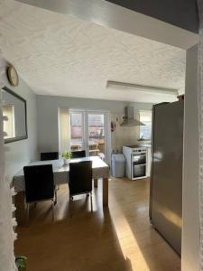 a kitchen with a table and chairs and a refrigerator at Harbour view in Cowes