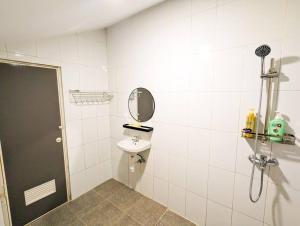 a bathroom with a sink and a mirror at Lovina A5 no 3 at Baloi Impian - Grand Batam Mall in Nagoya +22 photos