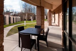 a black table and chairs on a patio at Courtyard Suffolk Chesapeake in Suffolk